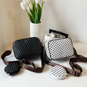 Detail of vintage square shoulder bags with geometric patterns and wide straps