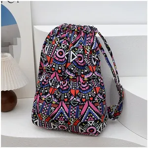 Detail of colorful geometric pattern and drawstring closure on ethnic style canvas backpack
