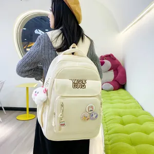 Detail of off-white backpack with YIGE BAG embroidery and cute cartoon rabbit badges