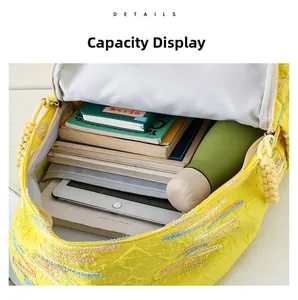 Capacity display of the yellow quilted backpack showing space for tablet and books
