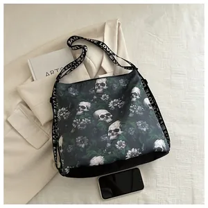 Detailed top view of black nylon crossbody bag featuring skull floral print and LOVE strap