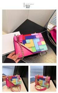 Detail of rose red crossbody bag with geometric color-block flap and golden chain strap