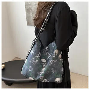 Detail of a large nylon crossbody bag featuring a skull print and wide LOVE straps