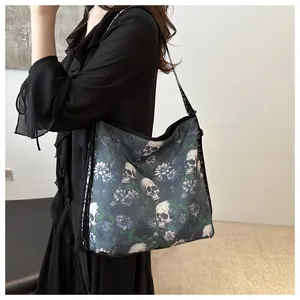 Close-up of skull and floral print nylon tote bag with printed love letter straps