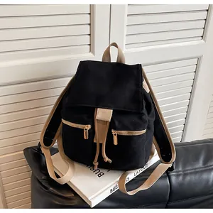 Detalle de mochila de lona negra con cordón ajustable y correas en color caqui