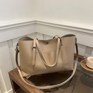Chic beige soft leather tote bag with front pocket and adjustable strap for women