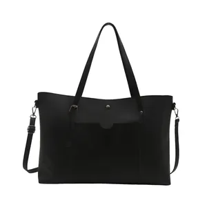 Minimalist black soft leather tote bag with front pocket and adjustable shoulder straps