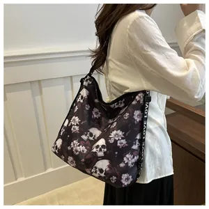 Detail of crossbody bag featuring skull floral print and LOVE letter strap design