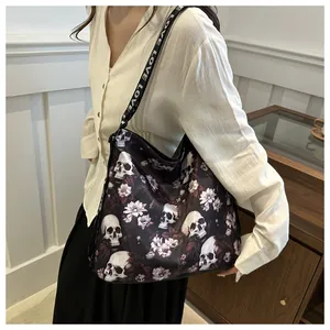 Detail of gothic nylon crossbody bag with skull print and LOVE pattern shoulder strap