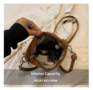 Top view of compact brown suede crossbody bag showing internal capacity for daily items