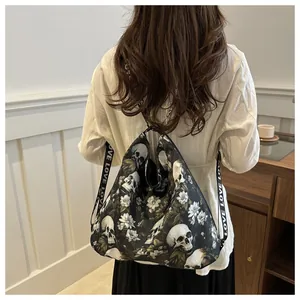 Model wearing a black nylon drawstring backpack with floral skull prints and LOVE straps
