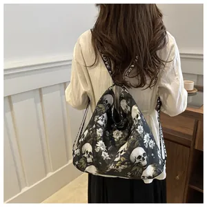 Detail of gothic floral skull drawstring backpack with LOVE lettered woven straps