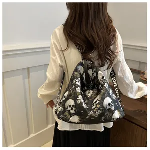 Close-up of black nylon crossbody bag featuring white skull floral print and LOVE strap