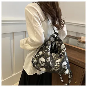 Detail of nylon crossbody bag featuring floral skull print and LOVE lettered strap