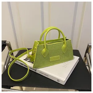 Detail of green woven texture and Fashion & Bags label on trapezoid crossbody handbag