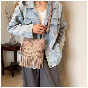 Brown fringe crossbody bag shown with denim jacket for stylish everyday styling look