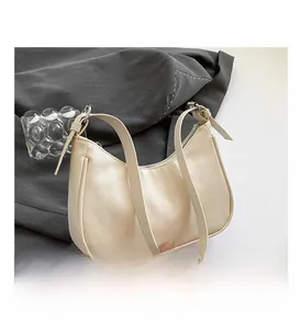 Macro detail of creamy quilted leather hobo bag with silver zipper and slim strap