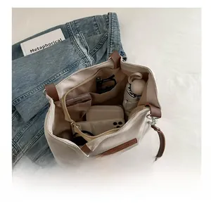Internal view of a large tote bag showing compartments filled with daily essentials