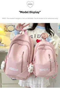 Pink waterproof nylon backpack detail showing large and small sizes with bear pendant