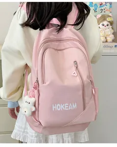 Pink waterproof nylon backpack with white HOKEAM logo and a cute plush bear pendant
