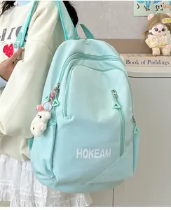 Mint green school backpack with HOKEAM logo and cute bear charm shown on model