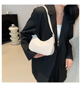 Minimalist white semi-moon shoulder bag styled with a professional black blazer jacket