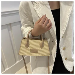 Detail of hand-woven trapezoid tote bag with premium leather handles and fashion logo