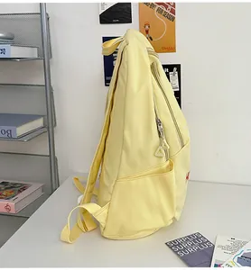 Detail of adjustable straps and side pocket on a cream yellow large capacity backpack