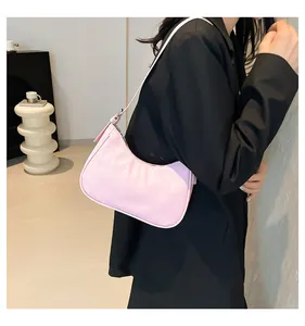 Detail of pink embossed leather baguette bag showing texture and silver zipper