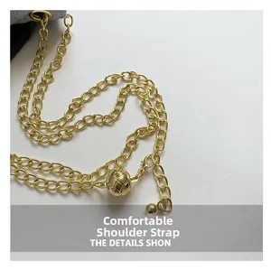 Detailed macro view of a gold chain strap featuring a quilted texture metal ball adjustment