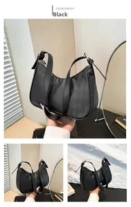 Detail of black quilted crossbody bag with rhombus stitching and crescent moon shape