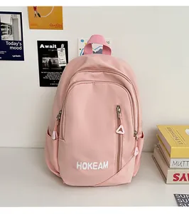 Pink minimalist backpack with HOKEAM logo print and side water bottle pockets