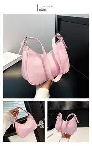 Detail of pink hobo bag featuring quilted diamond texture and adjustable strap