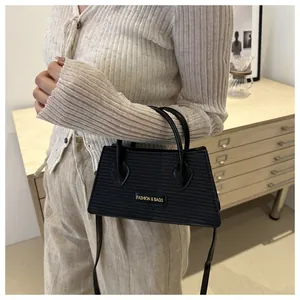 Close-up of black woven texture handbag with golden Fashion & Bags metal logo lettering