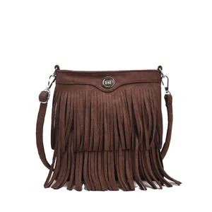 Brown vintage suede fringe crossbody bag with tiered tassels and metal emblem