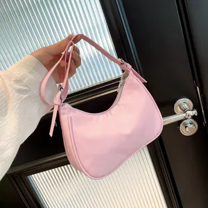 Chic pink crescent hobo bag with adjustable strap and textured nylon surface for women