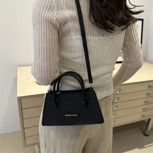 Minimalist black woven texture handbag with crossbody strap for elegant women fashion style