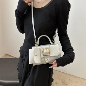 Chic silver metallic mini crossbody bag with top handle and matching coin purse charm