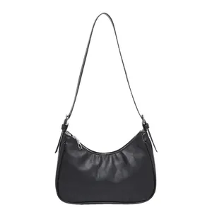 Minimalist black quilted hobo shoulder bag with silver zipper in a classic crescent shape