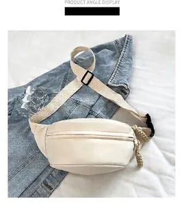 Detail of cream nylon waist bag featuring wide woven strap and durable black buckle
