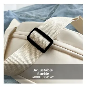 Close-up of adjustable black buckle and woven strap on a cream canvas crossbody bag