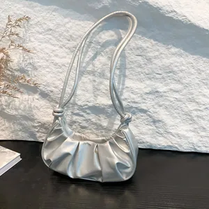 Chic silver ruched baguette bag with metallic finish and knot detail shoulder strap