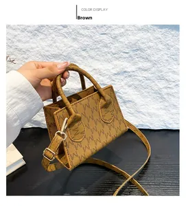 Detail view of brown PU leather bag featuring gold hardware and monogram pattern