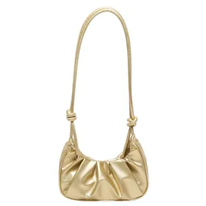 Metallic gold pleated croissant shoulder bag with knotted strap details for women