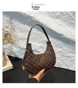 Detail view of coffee brown hobo bag with M-letter monogram pattern and side metal buckle