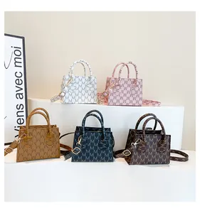 Group display of mini monogram tote bags in five colors with adjustable shoulder straps