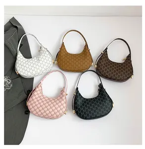 Collection of five monogrammed crescent shoulder bags in multiple colors with gold hardware