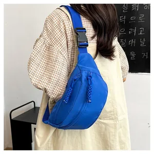 Detail of royal blue canvas waist bag featuring double zippers and durable buckle strap