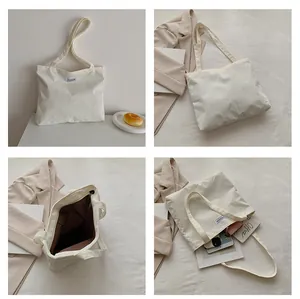 Macro shot showing beige corduroy texture, fashion label and spacious inner lining of tote