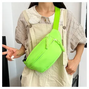 Detail of neon green nylon chest bag featuring thick woven rope zipper pulls and strap